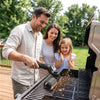 Black electric grill brush used on family outdoor barbecue grill